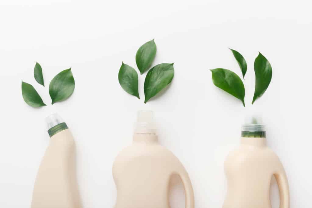 Choose bio concept. Different liquid detergents for wet home cleaning with quality and safety sign natural leaves, white background
